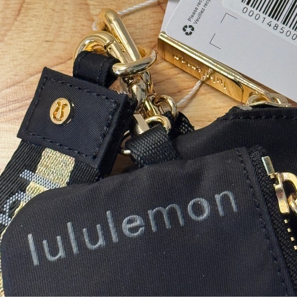 NWT Lululemon Dual Pouch Wristlet Black Gold Wordmark NWT - Picture 2 of 7